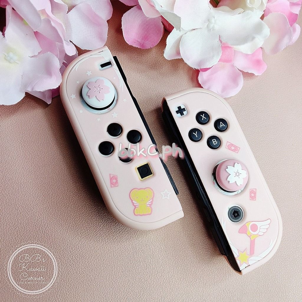 Sakura Thumb Grips for Nintendo Switch / Switch Lite - 2pcs White and Pink combo (Category: Controllers) located in Mandaluyong City. Submitted by bbkc.ph (Listing ID 1453630749, Image 1). Description: 🌸 Designed for Nintendo Switch & Switch Lite 🌸 Protects your original analog joysticks from dirt and wear and tear 🌸 May fit 3rd party controllers with small analog joysticks 🌸 Quantity: 2pcs 🌸 Material: Silicone 🌸 This variation has no cardb