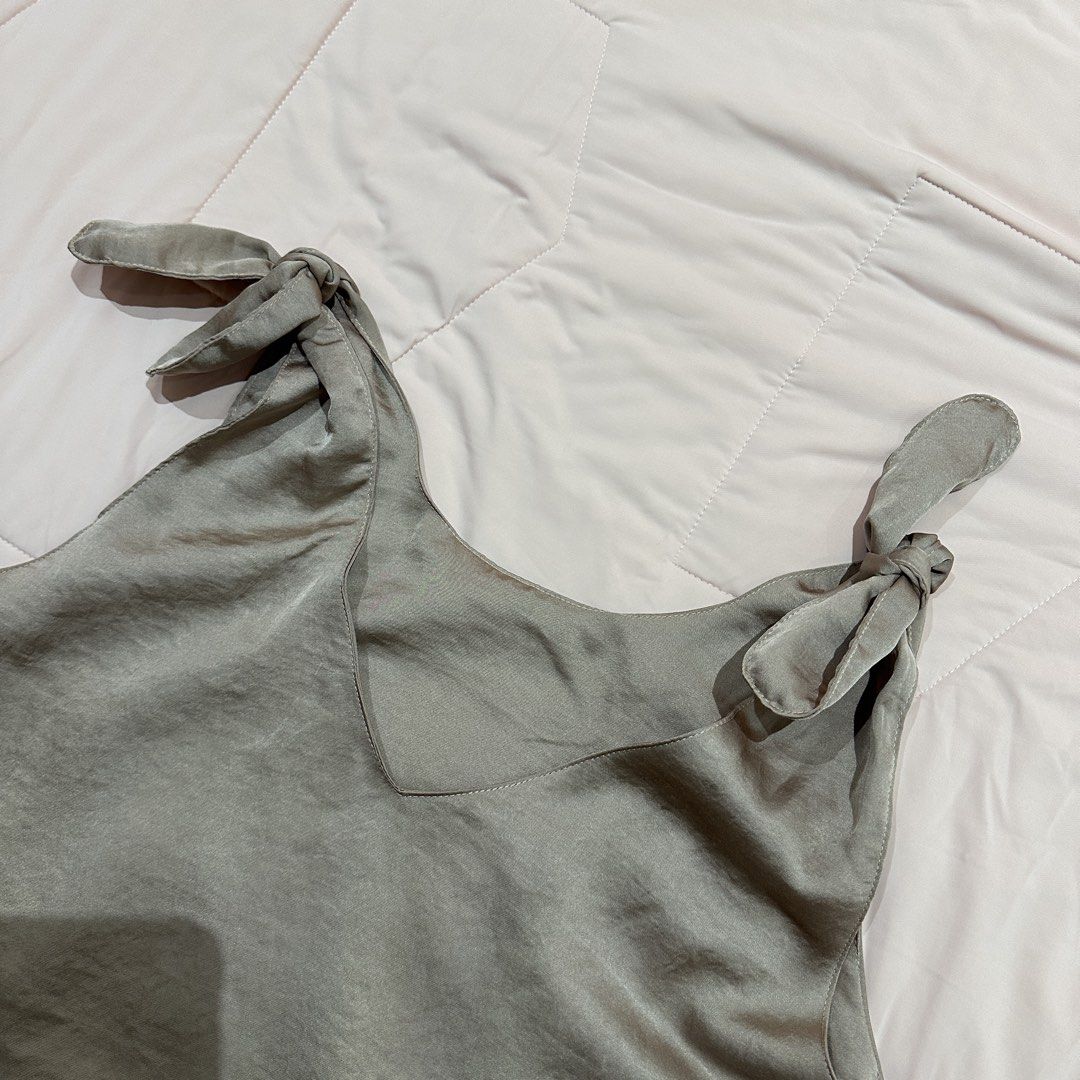 Satin Tie Shoulder V-Neck Tank Top (Category: Sleeveless) located in Quezon City. Submitted by timelessfinds (Listing ID 1453956683, Image 2). Description: - Grey satin tank top - V-neckline with adjustable tie shoulder straps - Silky, smooth material - Perfect for dressing up or down - Pairs well with jeans or skirts - Comfortable and stylish.