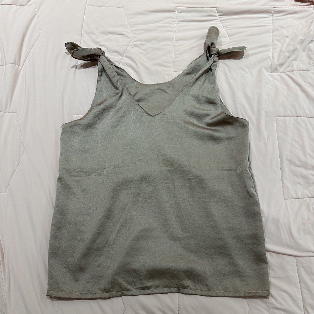 Satin Tie Shoulder V-Neck Tank Top (Category: Sleeveless) located in Quezon City. Submitted by timelessfinds (Listing ID 1453956683, Image 1). Description: - Grey satin tank top - V-neckline with adjustable tie shoulder straps - Silky, smooth material - Perfect for dressing up or down - Pairs well with jeans or skirts - Comfortable and stylish.