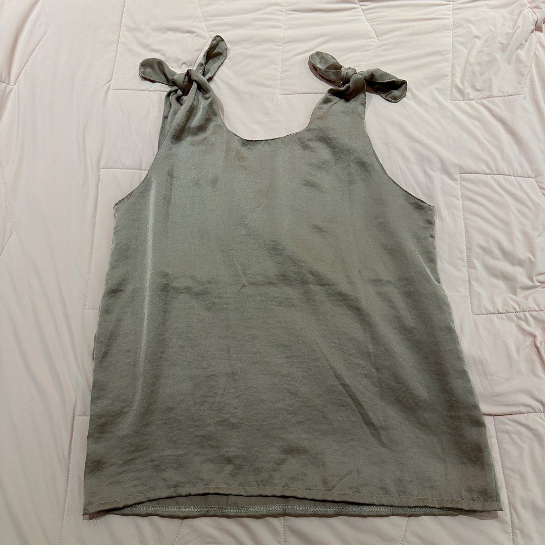 Satin Tie Shoulder V-Neck Tank Top (Category: Sleeveless) located in Quezon City. Submitted by timelessfinds (Listing ID 1453956683, Image 3). Description: - Grey satin tank top - V-neckline with adjustable tie shoulder straps - Silky, smooth material - Perfect for dressing up or down - Pairs well with jeans or skirts - Comfortable and stylish.