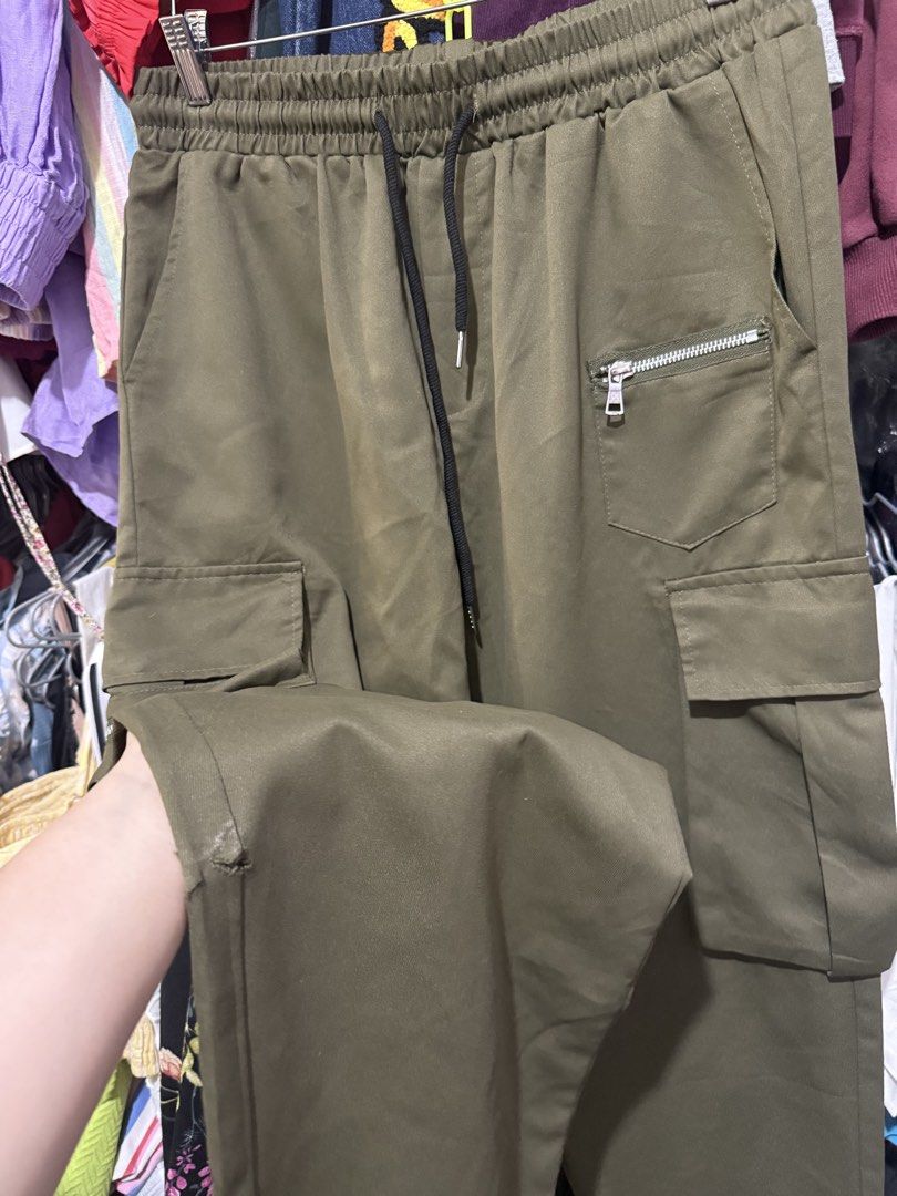 Shein Cargo Green Pants (Category: Other Bottoms) located in Antipolo. Submitted by harlowwillow (Listing ID 1453813704, Image 3). Description: LAST PRICE POSTED 100% Polyester soft hindi manipis and not too thick Large on tag W 16”-20” L 41” - Brand: Shein - Type: Cargo Pants - Color: Olive Green - Size: - Features: Elastic waistband with drawstring, multiple pockets including zippered ones - Style: Casual, Streetwear - flaw: small cut ALL SALES