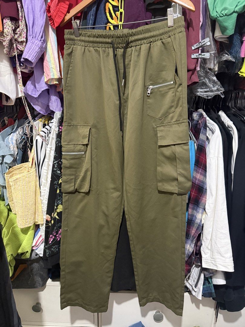 Shein Cargo Green Pants (Category: Other Bottoms) located in Antipolo. Submitted by harlowwillow (Listing ID 1453813704, Image 1). Description: LAST PRICE POSTED 100% Polyester soft hindi manipis and not too thick Large on tag W 16”-20” L 41” - Brand: Shein - Type: Cargo Pants - Color: Olive Green - Size: - Features: Elastic waistband with drawstring, multiple pockets including zippered ones - Style: Casual, Streetwear - flaw: small cut ALL SALES