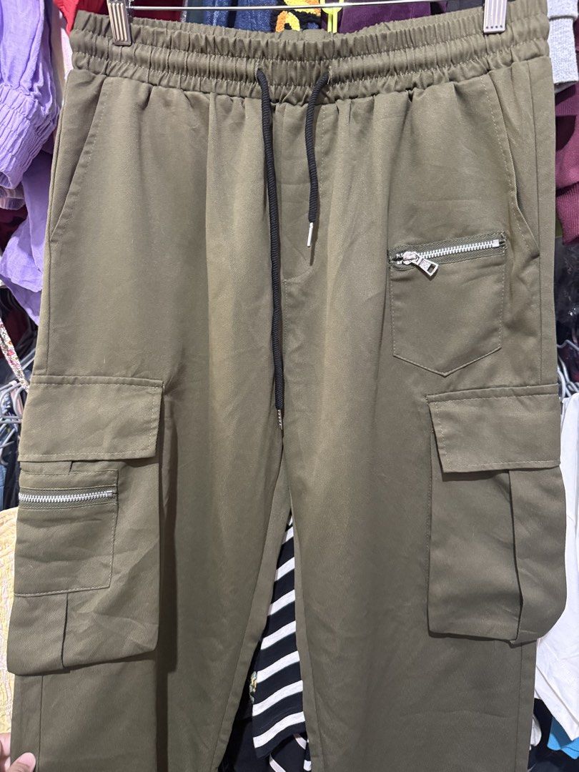 Shein Cargo Green Pants (Category: Other Bottoms) located in Antipolo. Submitted by harlowwillow (Listing ID 1453813704, Image 2). Description: LAST PRICE POSTED 100% Polyester soft hindi manipis and not too thick Large on tag W 16”-20” L 41” - Brand: Shein - Type: Cargo Pants - Color: Olive Green - Size: - Features: Elastic waistband with drawstring, multiple pockets including zippered ones - Style: Casual, Streetwear - flaw: small cut ALL SALES