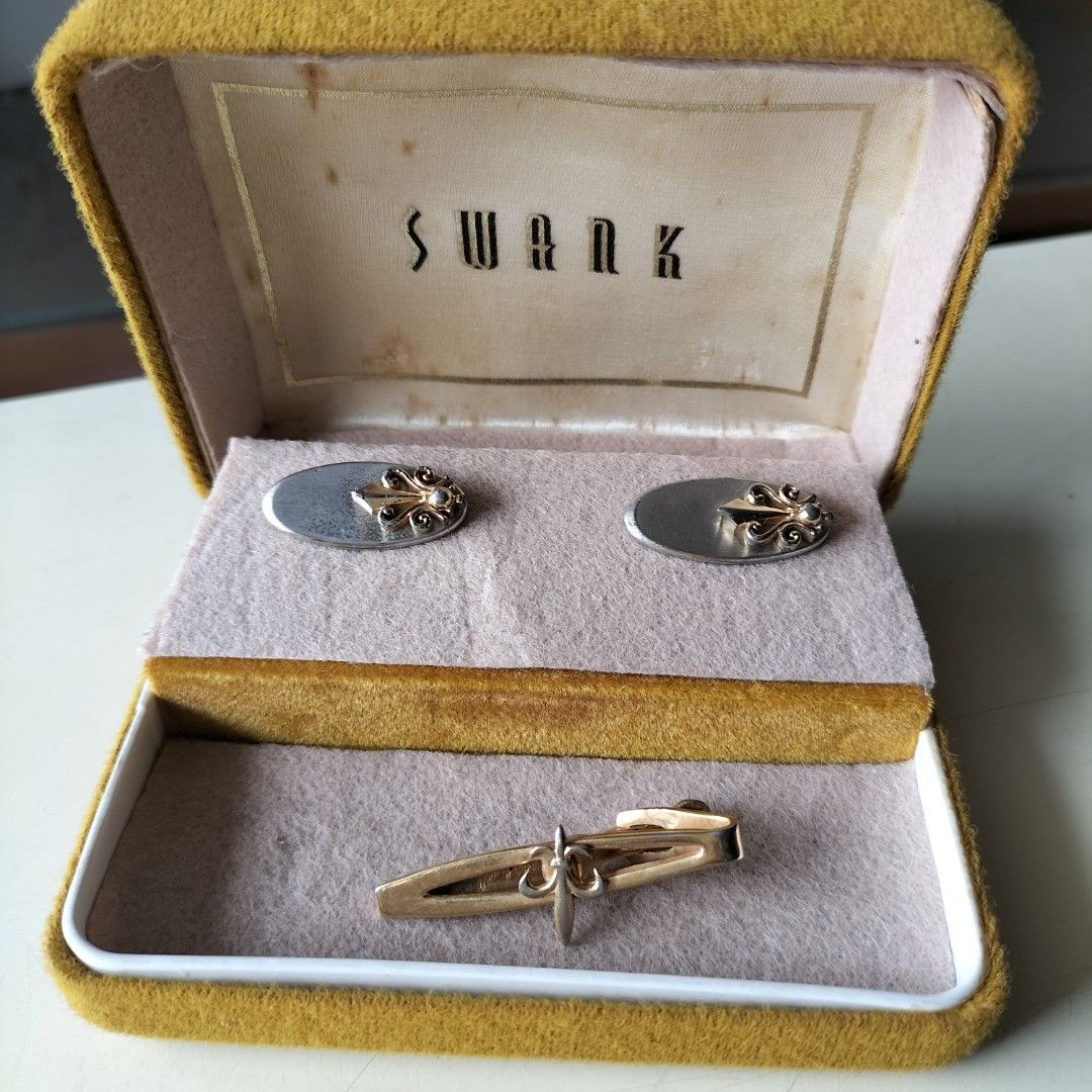 SWANK Cufflinks and rabbit Tie Clip (Category: Cuff Links) located in Paranaque City. Submitted by decluttering-all (Listing ID 1453835383, Image 1). Description: - Vintage SWANK cufflinks and tie clip set - Includes original yellow velvet box - Cufflinks: Silver-tone oval face with gold-tone ornate design - Tie Clip: Gold-tone with matching ornate design, Rabbit brand engraved - Ideal for formal wear or collectors - Box shows some wear but is in