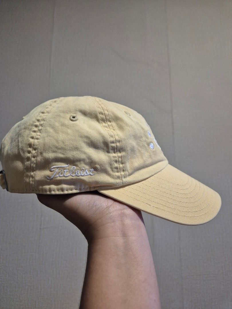 Titleist Golf Cap Yellow Adjustable Strap (Category: Caps & Hats) located in Manila. Submitted by rpaul88 (Listing ID 1453987565, Image 2). Description: - Yellow Titleist golf cap - Adjustable strap for a comfortable fit - Embroidered Titleist logo on the side - Crown-like design embroidered on the front - 'MILLER PUTTER 5' embroidered on the brim - Ideal for sunny days on the golf course or casual outings.