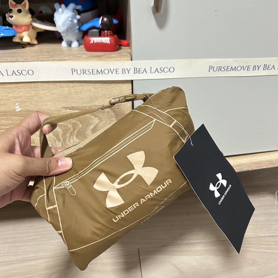 Under armour packable duffle bag 25L (Category: Backpacks) located in Calamba. Submitted by biyanggg (Listing ID 1450093517, Image 1). Description: W paperbag.