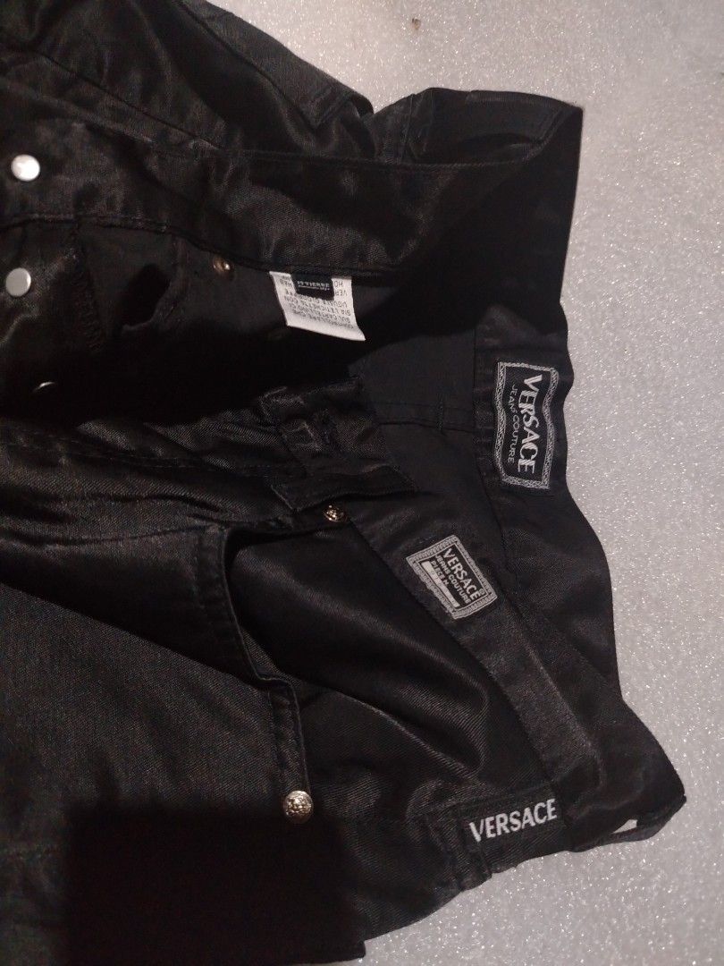 Versace jeans couture (Category: Luxury Apparel) located in Manila. Submitted by rockandrolly (Listing ID 1453938697, Image 3). Description: Brand: Versace Jeans Couture (authentic, with iconic Medusa logo, branded hardware, and hologram verification tag) Origin: Made in Italy Style: Premium straight-fit trousers in glossy black satin-finish fabric Features: Signature Versace branding on waistband, pockets, and hardware; classic 5-pocket cut; hig