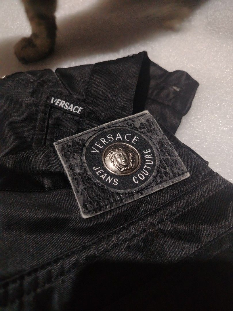 Versace jeans couture (Category: Luxury Apparel) located in Manila. Submitted by rockandrolly (Listing ID 1453938697, Image 2). Description: Brand: Versace Jeans Couture (authentic, with iconic Medusa logo, branded hardware, and hologram verification tag) Origin: Made in Italy Style: Premium straight-fit trousers in glossy black satin-finish fabric Features: Signature Versace branding on waistband, pockets, and hardware; classic 5-pocket cut; hig