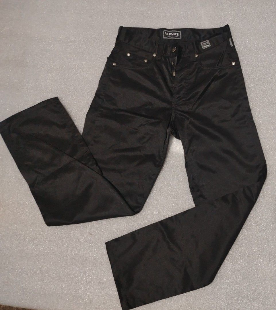 Versace jeans couture (Category: Luxury Apparel) located in Manila. Submitted by rockandrolly (Listing ID 1453938697, Image 1). Description: Brand: Versace Jeans Couture (authentic, with iconic Medusa logo, branded hardware, and hologram verification tag) Origin: Made in Italy Style: Premium straight-fit trousers in glossy black satin-finish fabric Features: Signature Versace branding on waistband, pockets, and hardware; classic 5-pocket cut; hig
