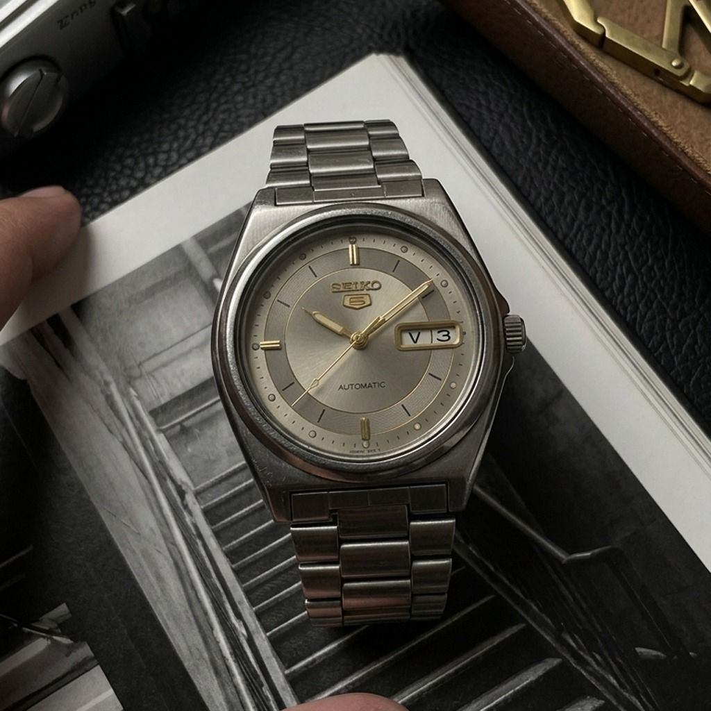 Vintage Seiko 5 Automatic Watch (Category: Men's Watches) located in Caloocan City. Submitted by oddstar_db4479 (Listing ID 1453910344, Image 1). Description: Reference: 7S26-0310 Movement: Seiko Cal. 7S26 Automatic (21 Jewels) Case Size: Approx. 36–37 mm Crystal: Hardlex Functions: Day-Date Dial: Silver sunburst with gold-tone chapter ring and indices Case: Stainless steel Bracelet: Stainless steel bracelet Crown: Recessed at 4 o'clock Condition