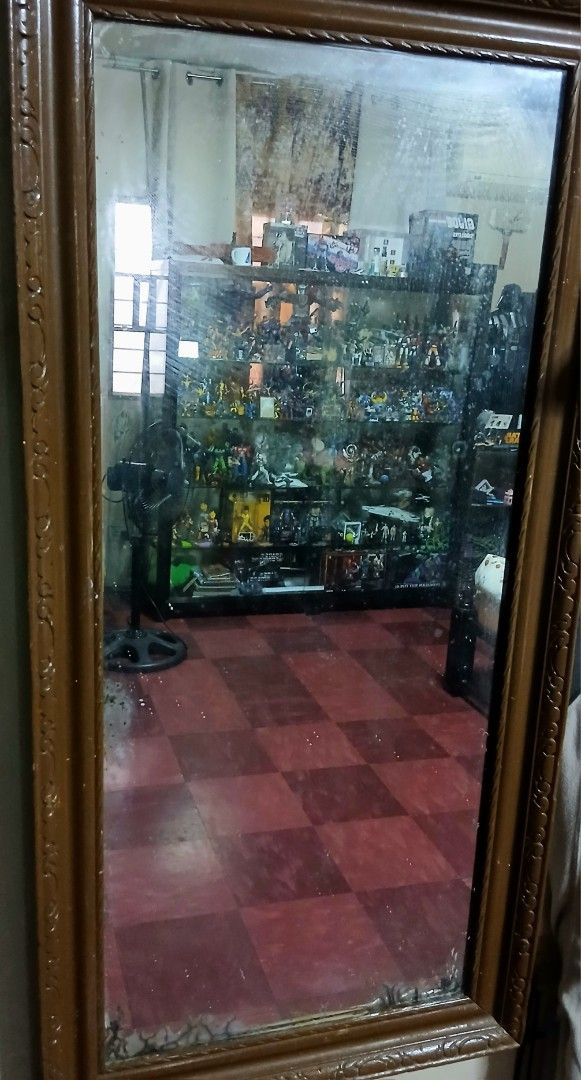 Vintage Wooden Framed Mirror (Category: Mirrors) located in Quezon City. Submitted by mrs.maria (Listing ID 1453940313, Image 2). Description: - Large mirror with a decorative wooden frame. - Features intricate carvings on the frame. - Mirror surface has some minor marks and smudges. - Ideal size for a full-length mirror or hallway accent. - Provides good room reflection. - Sold in its current condition (as is)..