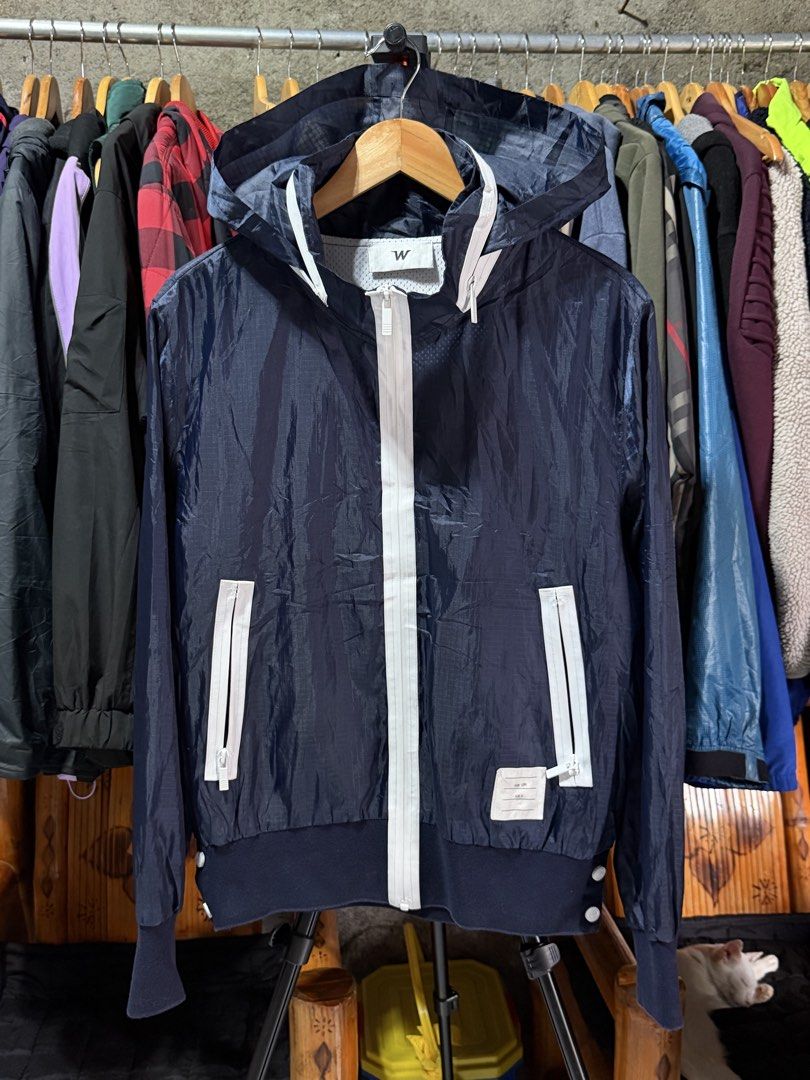 W Jacket Navy Blue Hooded Windbreaker Size 4 (Category: Coats, Jackets and Outerwear) located in Bulacan. Submitted by eman02 (Listing ID 1453890548, Image 1). Description: - Navy blue hooded windbreaker jacket - Full zip front with white accents - Two zip pockets - Ribbed cuffs and hem - Lightweight and ideal for layering - Suitable for casual wear or outdoor activities.
