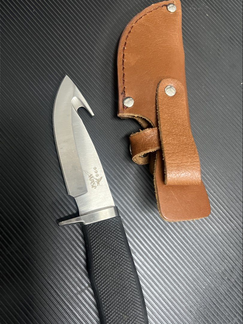 WASP Fixed Blade Knife with Leather Sheath (Category: Knives & Chopping Boards) located in Cebu City. Submitted by zershrovv (Listing ID 1453910525, Image 1). Description: - WASP fixed blade knife - Textured black handle - Brown leather sheath included - Built-in hook for cutting rope or line - Perfect for outdoor activities - Sheath features a belt loop for easy carrying.