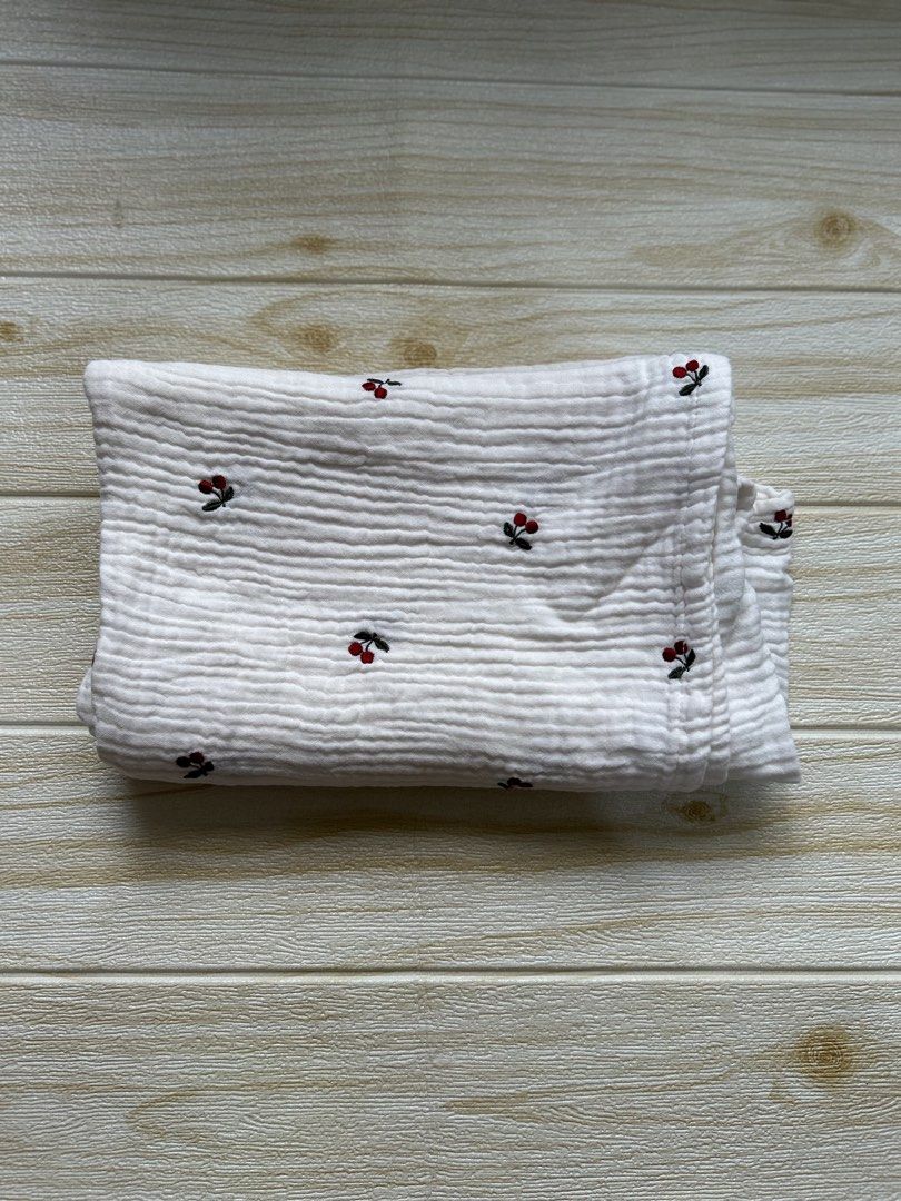 white muslin swaddle blanket (Category: Baby Toiletries & Grooming) located in Cebu City. Submitted by yjainani (Listing ID 1453988849, Image 1). Description: featuring a red cherry embroidered pattern. suitable for nursing cover.