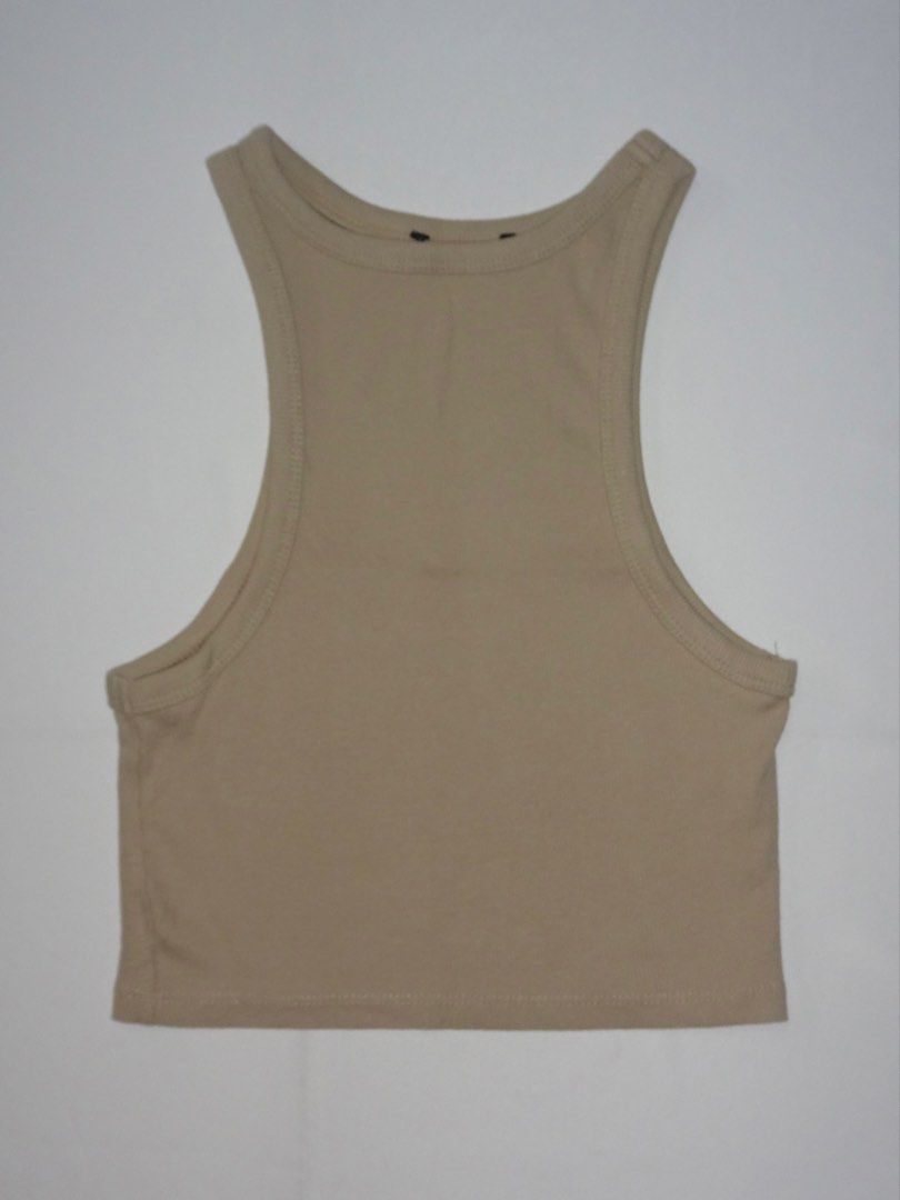 Beige Ribbed Racerback Tank Top (Category: Sleeveless) located in Manila. Submitted by kim.declutterss (Listing ID 1453953929, Image 1). Description: - Size: Fits XS-small - Basic beige ribbed tank top - Racerback style - Soft and comfortable material - Perfect for layering or wearing on its own - Simple and versatile, easy to match with any outfit - Color may vary due to lighting.