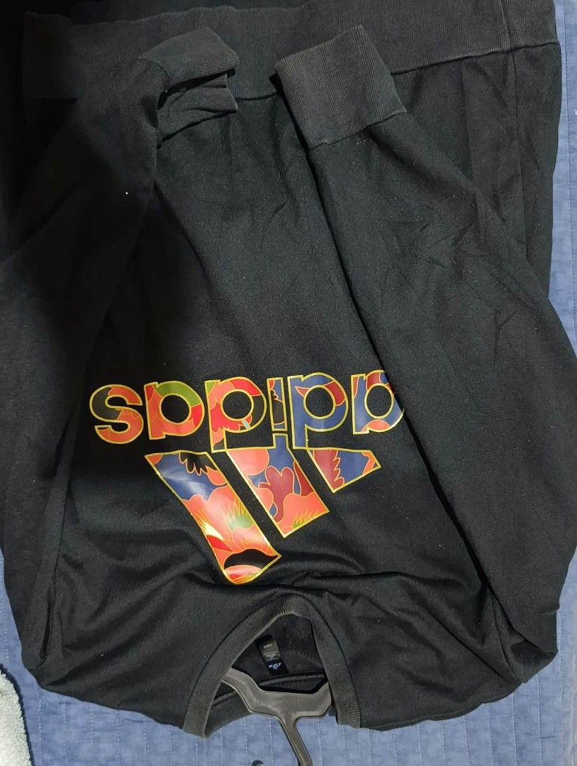 Adidas Black Sweater (Category: Tshirts & Polo Shirts ) located in Naga. Submitted by brightsideofthemoon (Listing ID 1454147576, Image 1). Description: - Black long sleeve Adidas t-shirt - Features iconic Adidas logo with a vibrant floral pattern - Comfortable and stylish for casual wear - Size Large.