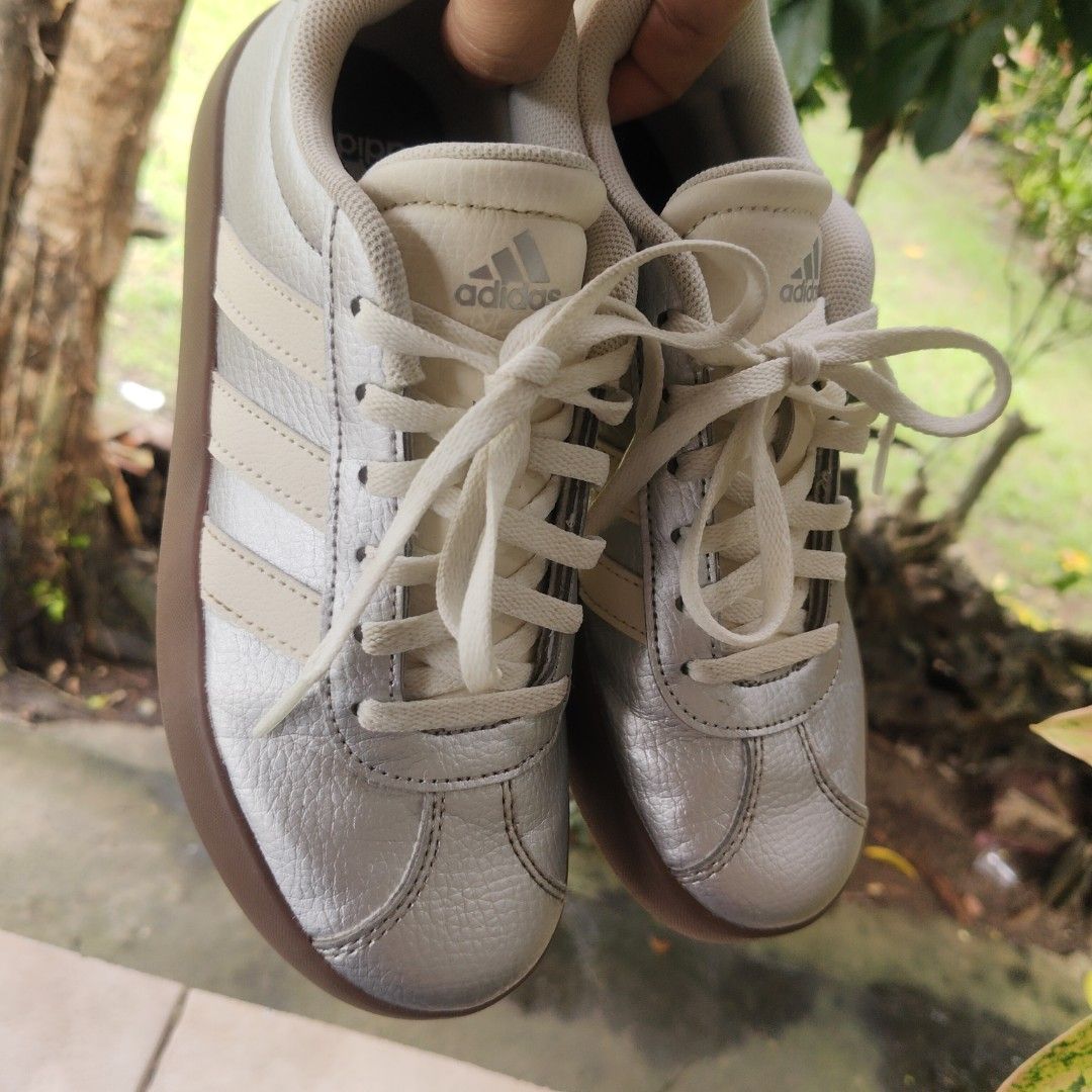 Adidas Silver Sneakers with Cream Stripes (Category: Sneakers) located in Iriga City. Submitted by twin28 (Listing ID 1454050371, Image 2). Description: - Classic silver Adidas low-top sneakers - Features cream stripes and a gum sole - Lace-up closure for a secure fit - Perfect for everyday casual wear .