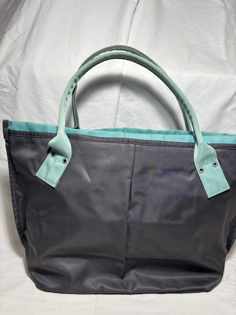 AGNES B ZIPPERED TOTE (Category: Luxury Bags & Wallets) located in Taguig. Submitted by vittelina (Listing ID 1454092542, Image 2). Description: -grey with teal handles and lining - nylon material, lightweight - clean lining, handles are discolored - no tear (punit) on the nylon material - spacious - with dust bag -12 W base, 18 W body x 11 H x 5 1/2 D inches .