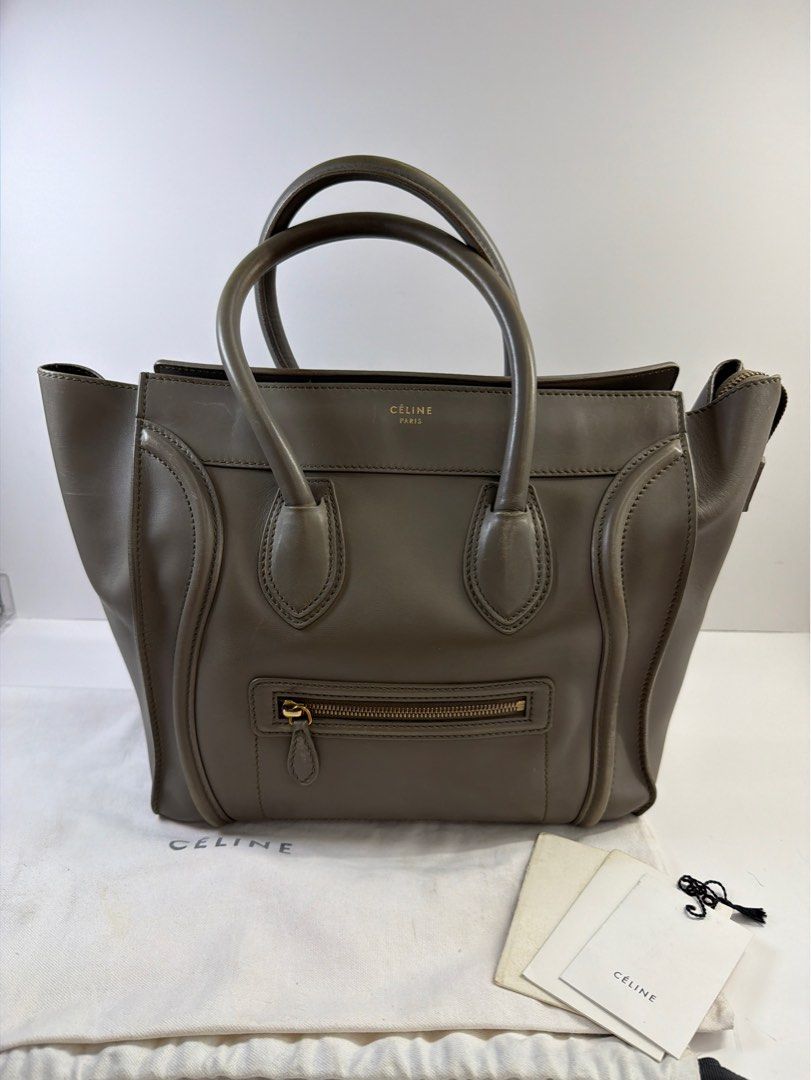 Authentic Celine Mini Luggage Tote Bag Grey Leather (Category: Luxury Bags & Wallets) located in Quezon City. Submitted by shoppingcartmnl (Listing ID 1454067113, Image 2). Description: - Authentic Celine Mini Luggage tote - Color: Grey - Material: Calfskin - Lining: Lambskin - Features: Front zip pocket, top handles - Includes: Dust bag, authenticity cards - Condition: Visible scuffs on leather and handles - Perfect for everyday use.