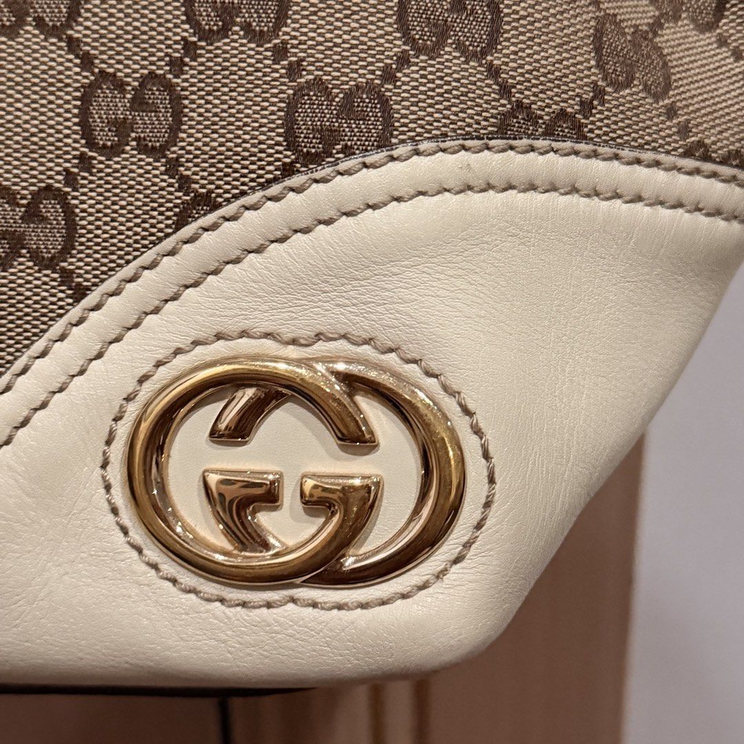 Authentic Gucci Britt Tote (Category: Luxury Bags & Wallets) located in San Pedro. Submitted by love.bruce10 (Listing ID 1454155219, Image 2). Description: - Stylish brown tote bag with white leather trimmings - Durable canvas material - Spacious interior - Classic and versatile design - slight tarnish in logo - signs of use .