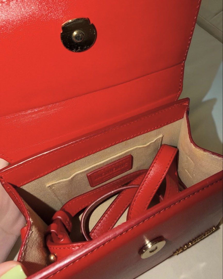 Authentic JACQUEMUS Le Chiquito Noeud in Red (Category: Luxury Bags & Wallets) located in Manila. Submitted by justinsaliba (Listing ID 1454180174, Image 2). Description: Selling my pre-loved Jacquemus Le Chiquito Noeud mini bag in vibrant red. Iconic extendable coiled top-handle design with gold-tone hardware. Product Details & Features: • Color: Bright Red • Material: 100% Smooth Calfskin Leather • Hardware: Gold-tone JACQUEMUS metal logo • Inc