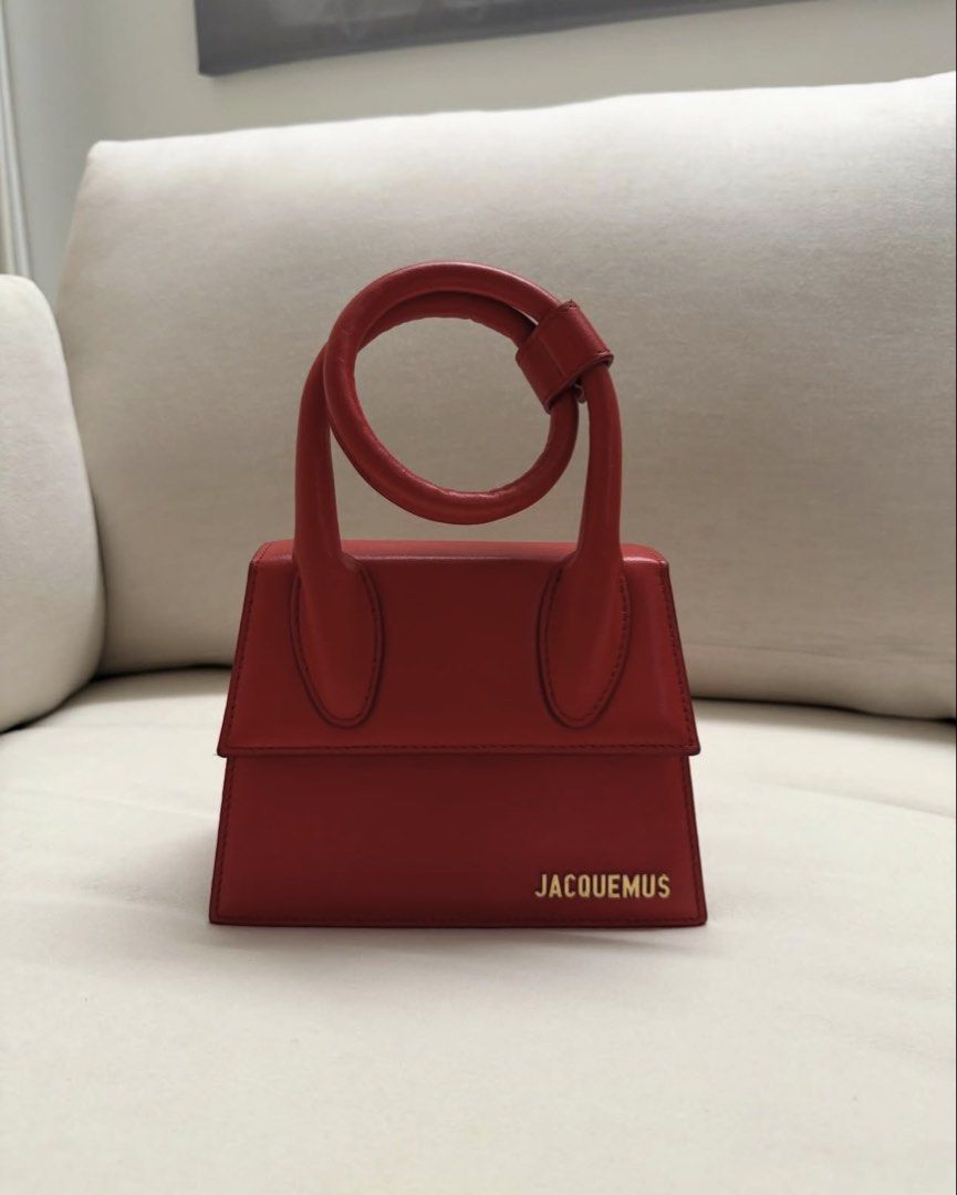 Authentic JACQUEMUS Le Chiquito Noeud in Red (Category: Luxury Bags & Wallets) located in Manila. Submitted by justinsaliba (Listing ID 1454180174, Image 1). Description: Selling my pre-loved Jacquemus Le Chiquito Noeud mini bag in vibrant red. Iconic extendable coiled top-handle design with gold-tone hardware. Product Details & Features: • Color: Bright Red • Material: 100% Smooth Calfskin Leather • Hardware: Gold-tone JACQUEMUS metal logo • Inc