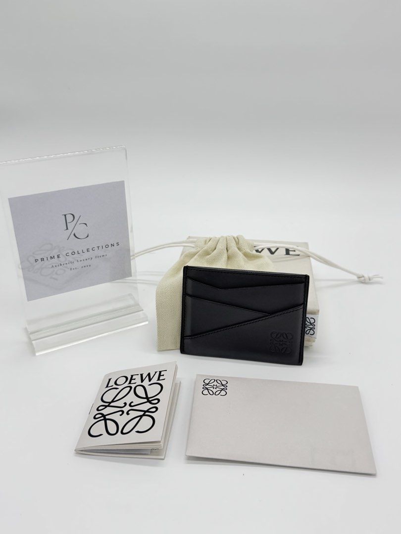 Authentic Loewe Puzzle Cardholder in Dark Grey (Category: Luxury Bags & Wallets) located in Mandaluyong City. Submitted by primecollections.ph (Listing ID 1454038333, Image 1). Description: Loewe Puzzle Cardholder Guaranteed authentic. Money back if proven fake. Selling for 18,000 only. Slightly nego. Condition: 9.2-9.5/10 | Very good condition Directly bought from the store in Marina Bay, Singapore. Barely used, only creases from the cards. Plea