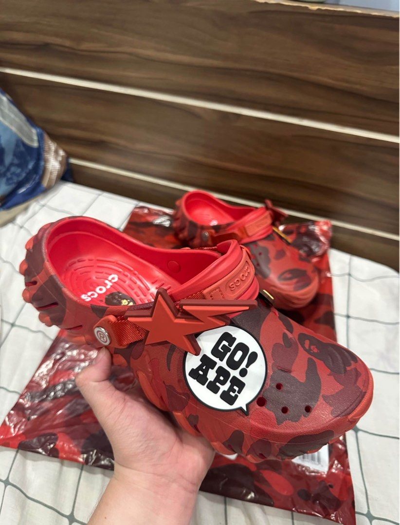 BAPE x Crocs Red Camo Clogs (Category: Slippers & Slides) located in Manila. Submitted by yagamilori (Listing ID 1454067161, Image 2). Description: - Limited edition Red BAPE x Crocs clogs - Features signature BAPE camo pattern - Includes 'GO! APE!' Jibbitz - Comes with original packaging - A must-have for collectors!.