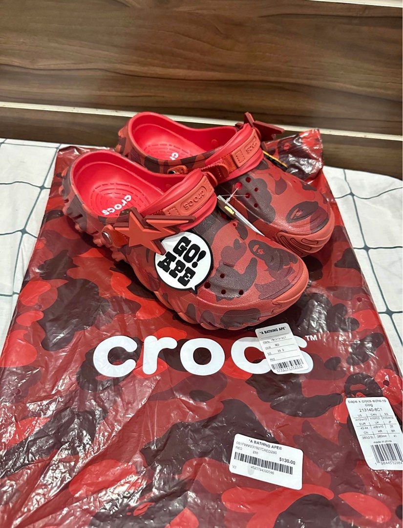 BAPE x Crocs Red Camo Clogs (Category: Slippers & Slides) located in Manila. Submitted by yagamilori (Listing ID 1454067161, Image 3). Description: - Limited edition Red BAPE x Crocs clogs - Features signature BAPE camo pattern - Includes 'GO! APE!' Jibbitz - Comes with original packaging - A must-have for collectors!.