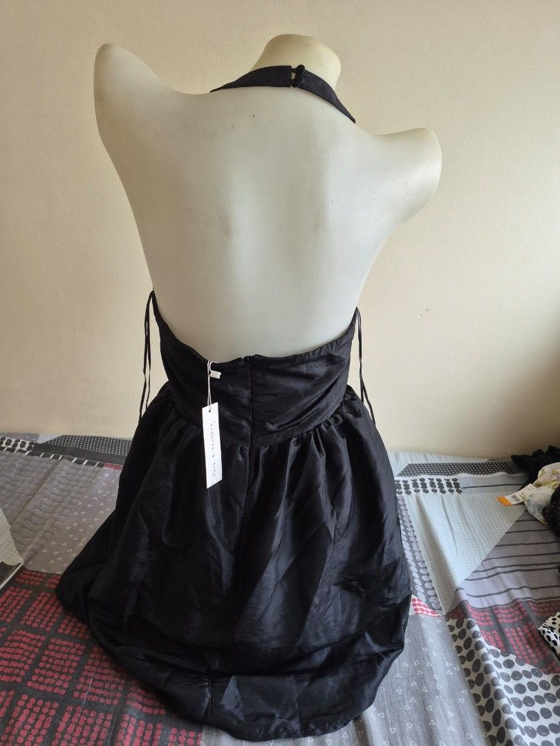 Black Halter Neck Dress with Tie Back (Category: Dresses) located in Pasig City. Submitted by ces.maranan16 (Listing ID 1454089268, Image 3). Description: - Elegant black halter neck dress - Flowy skirt with a beautiful sheen - Elasticated waist with adjustable tie-back detail - Ideal for parties, nights out, or special occasions - Tag still attached - Estimated size: Small to Medium (S/M).