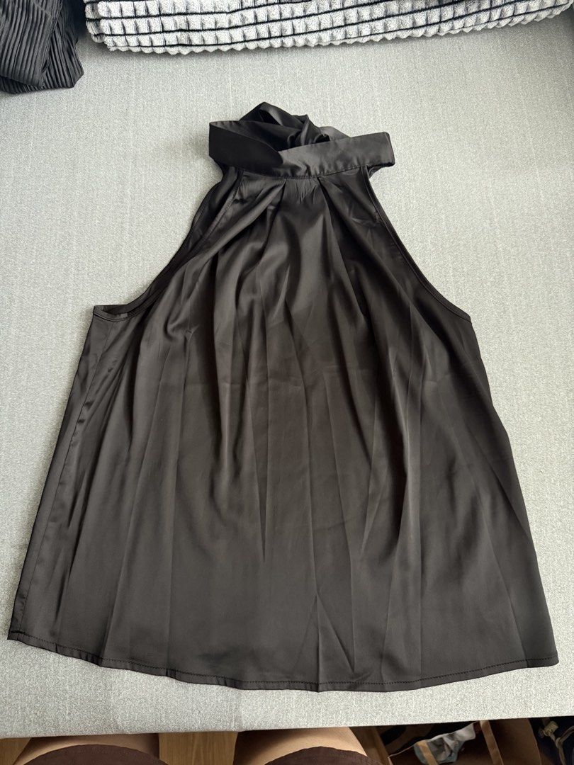 Black Halter Neck Top with Tie Detail (Category: Sleeveless) located in Tuguegarao City. Submitted by Jarah (Listing ID 1454079257, Image 1). Description: - Chic satin-like black top - Elegant halter neck with adjustable back tie - Flattering V-neck cutout detail - Sleeveless design with a stylish wide hem - Perfect for both casual and dressy looks.