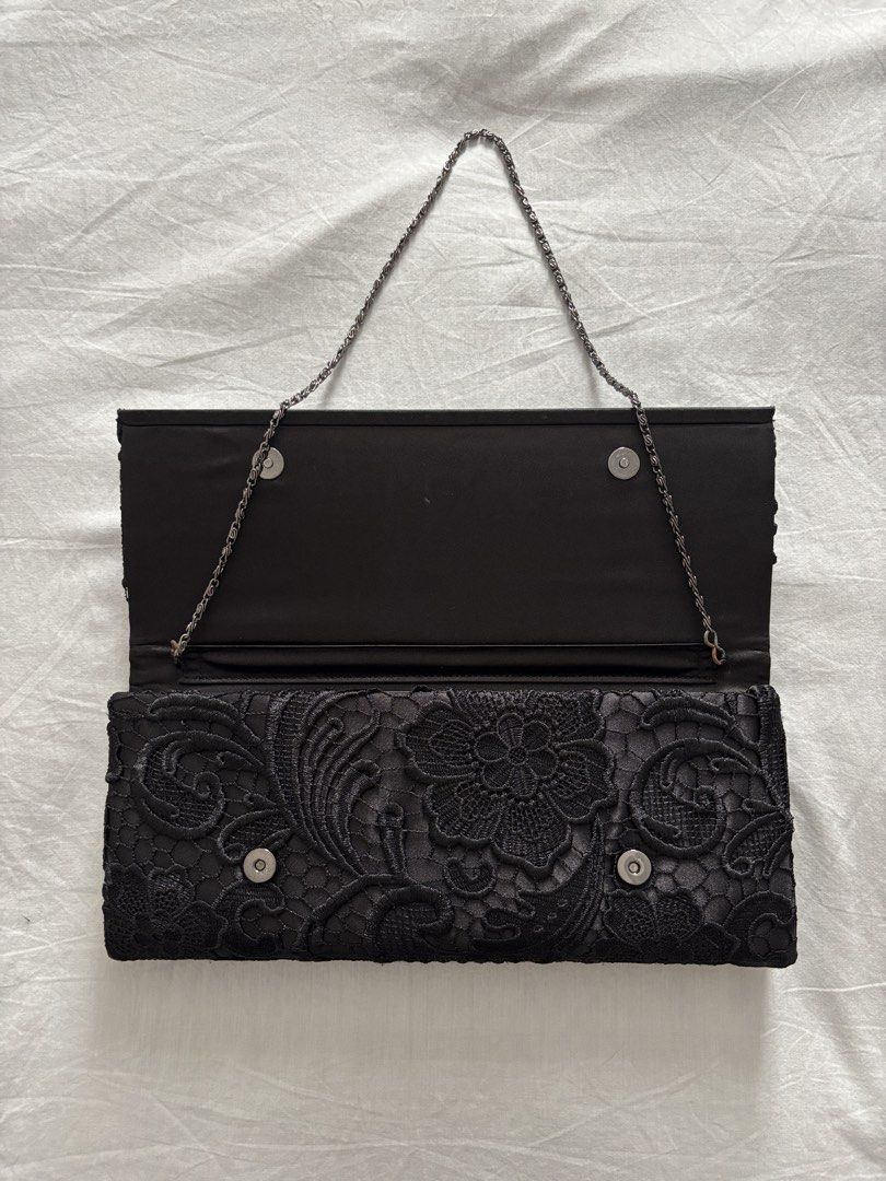 Black Lace Clutch Bag with Chain Strap (Category: Clutches) located in Quezon City. Submitted by marlo19 (Listing ID 1454010540, Image 3). Description: Black lace clutch bag. Bought from Accessorize. Has a detachable chain strap. Magnetic closure. Inside has a small pocket. Great for evenings out or special occasions. See photos for measurements.
