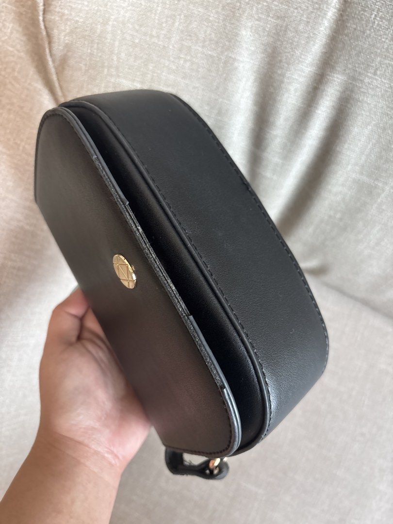 Black Saddle Crossbody Bag with Gold Clasp (Category: Cross-body Bags) located in Paranaque City. Submitted by jujudeclutterss (Listing ID 1454023978, Image 3). Description: - Bought from Malaysia - Cute black saddle bag - Secure gold clasp closure - Adjustable strap for comfort - Spacious main compartment - Fits your daily essentials (phone, wallet, keys) - Clean interior - Minor signs of wear on the exterior, adding character - Ideal for everyd