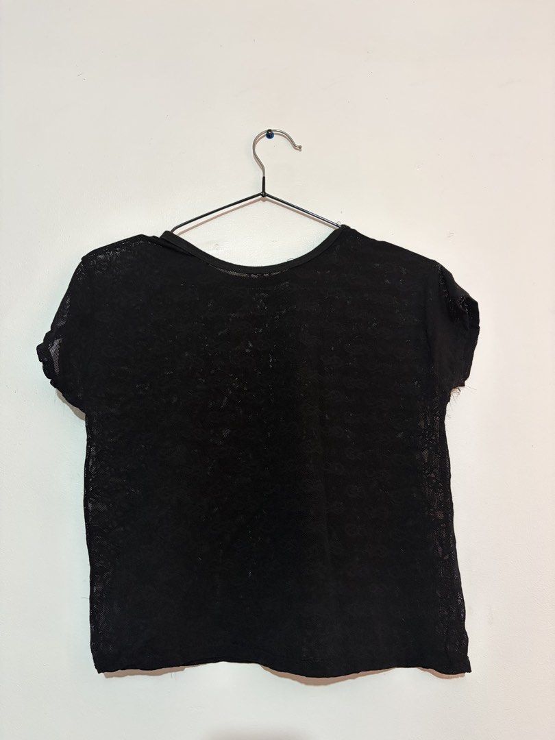 Black Sheer Lace T-shirt (Category: Shirts) located in Manila. Submitted by domhoards (Listing ID 1454171533, Image 2). Description: - Black t-shirt with a sheer lace pattern - Short sleeves and round neckline - Lightweight and airy fabric - Perfect for layering or wearing on its own - Effortlessly style up or down.