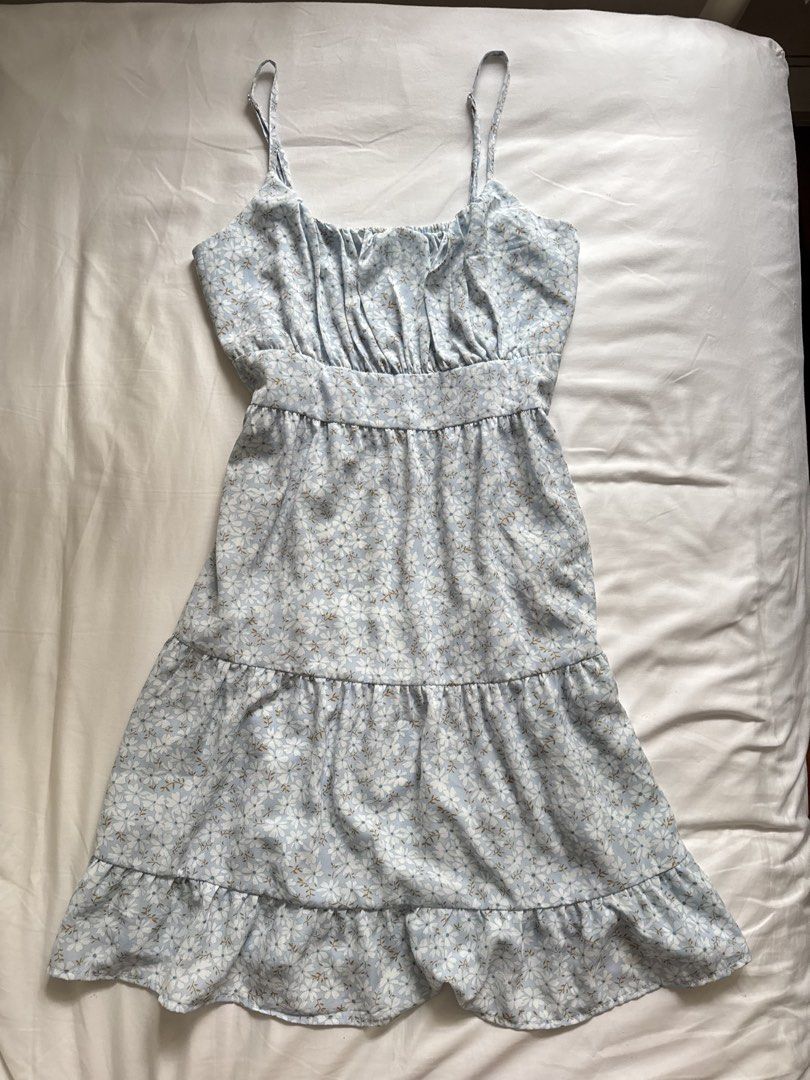 Blue Floral Tiered Mini Dress (Category: Dresses) located in Manila. Submitted by calmphoenix.7846bf (Listing ID 1454053809, Image 1). Description: - Adorable blue mini dress - Features a charming white and yellow floral print - Adjustable spaghetti straps for a perfect fit - Tiered, ruffled hem for a playful look - Gathered detail on the bodice - Ideal for summer days and casual outings - Effortless to wear and style.