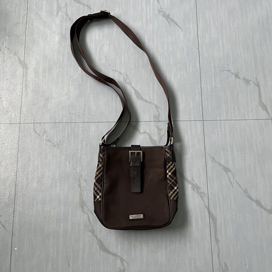 Burberry Brown Nova Check Crossbody Bag (Authentic) (Category: Luxury Bags & Wallets) located in Cavite. Submitted by newclassicwear (Listing ID 1454069128, Image 1). Description: Size 8width 8length Excellent Condition. Lighly Used No Major Issue. - Authentic Burberry crossbody bag - Features classic Nova Check pattern on the sides - Genuine leather strap and buckle detail - Adjustable strap for customized comfort - Ideal size for carrying daily