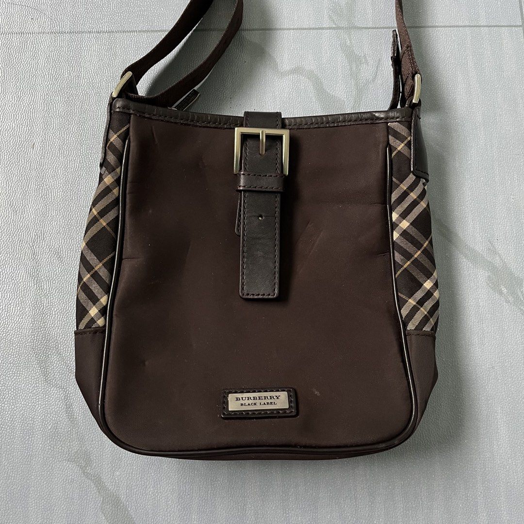 Burberry Brown Nova Check Crossbody Bag (Authentic) (Category: Luxury Bags & Wallets) located in Cavite. Submitted by newclassicwear (Listing ID 1454069128, Image 2). Description: Size 8width 8length Excellent Condition. Lighly Used No Major Issue. - Authentic Burberry crossbody bag - Features classic Nova Check pattern on the sides - Genuine leather strap and buckle detail - Adjustable strap for customized comfort - Ideal size for carrying daily