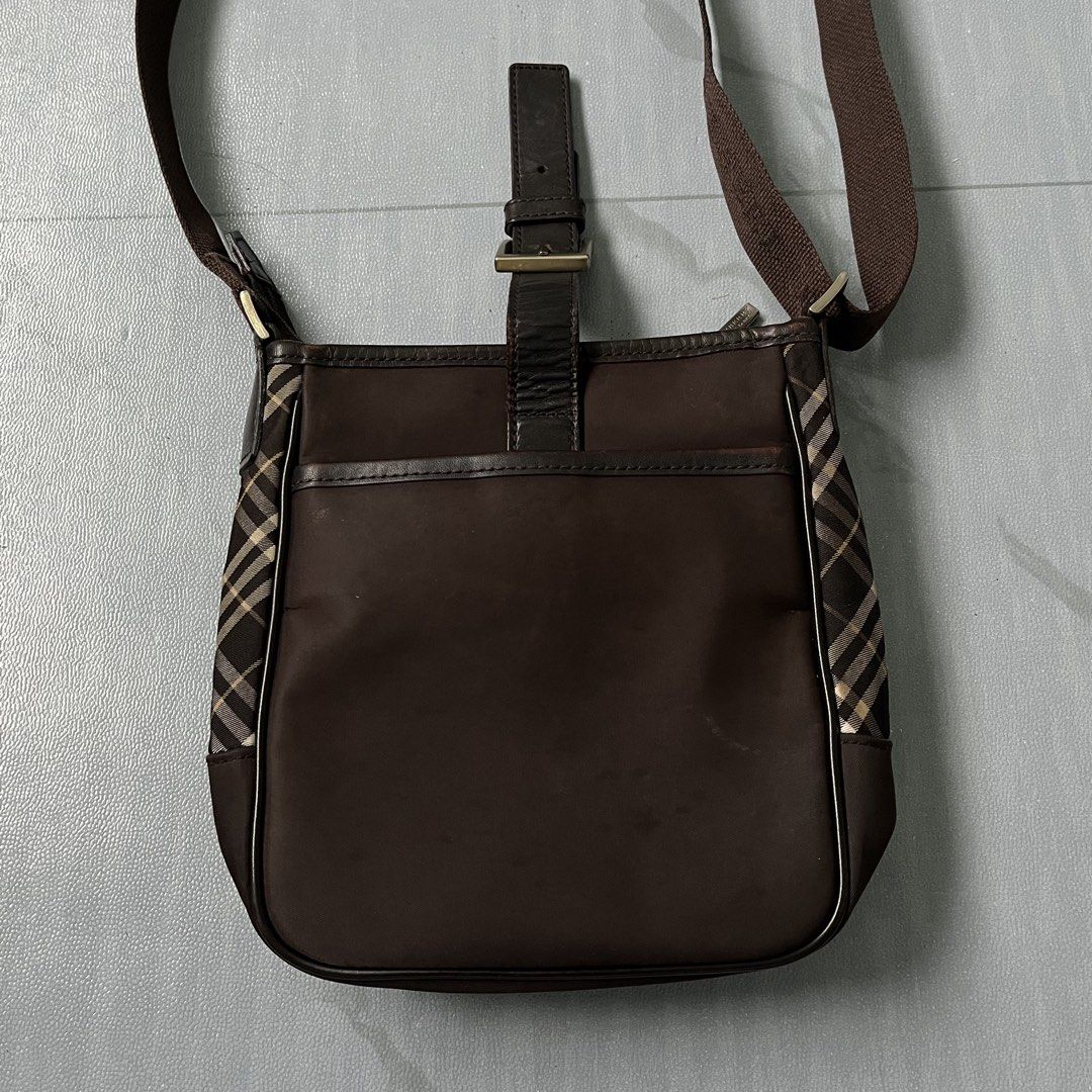 Burberry Brown Nova Check Crossbody Bag (Authentic) (Category: Luxury Bags & Wallets) located in Cavite. Submitted by newclassicwear (Listing ID 1454069128, Image 3). Description: Size 8width 8length Excellent Condition. Lighly Used No Major Issue. - Authentic Burberry crossbody bag - Features classic Nova Check pattern on the sides - Genuine leather strap and buckle detail - Adjustable strap for customized comfort - Ideal size for carrying daily