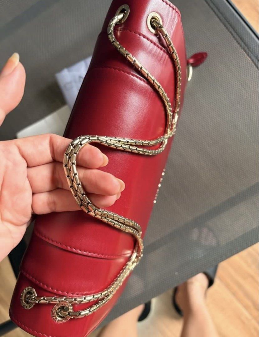 BVLGARI Serpenti Red Leather Shoulder Bag (Category: Luxury Bags & Wallets) located in Naga. Submitted by christinescollections (Listing ID 1454053607, Image 3). Description: - Authentic BVLGARI Serpenti bag in vibrant red leather. - Elegant gold chain strap for versatile wear. - Iconic snake head closure with exquisite enamel details. - Interior features convenient zippered pockets. - Comes complete with original dust bag and authenticity card. 