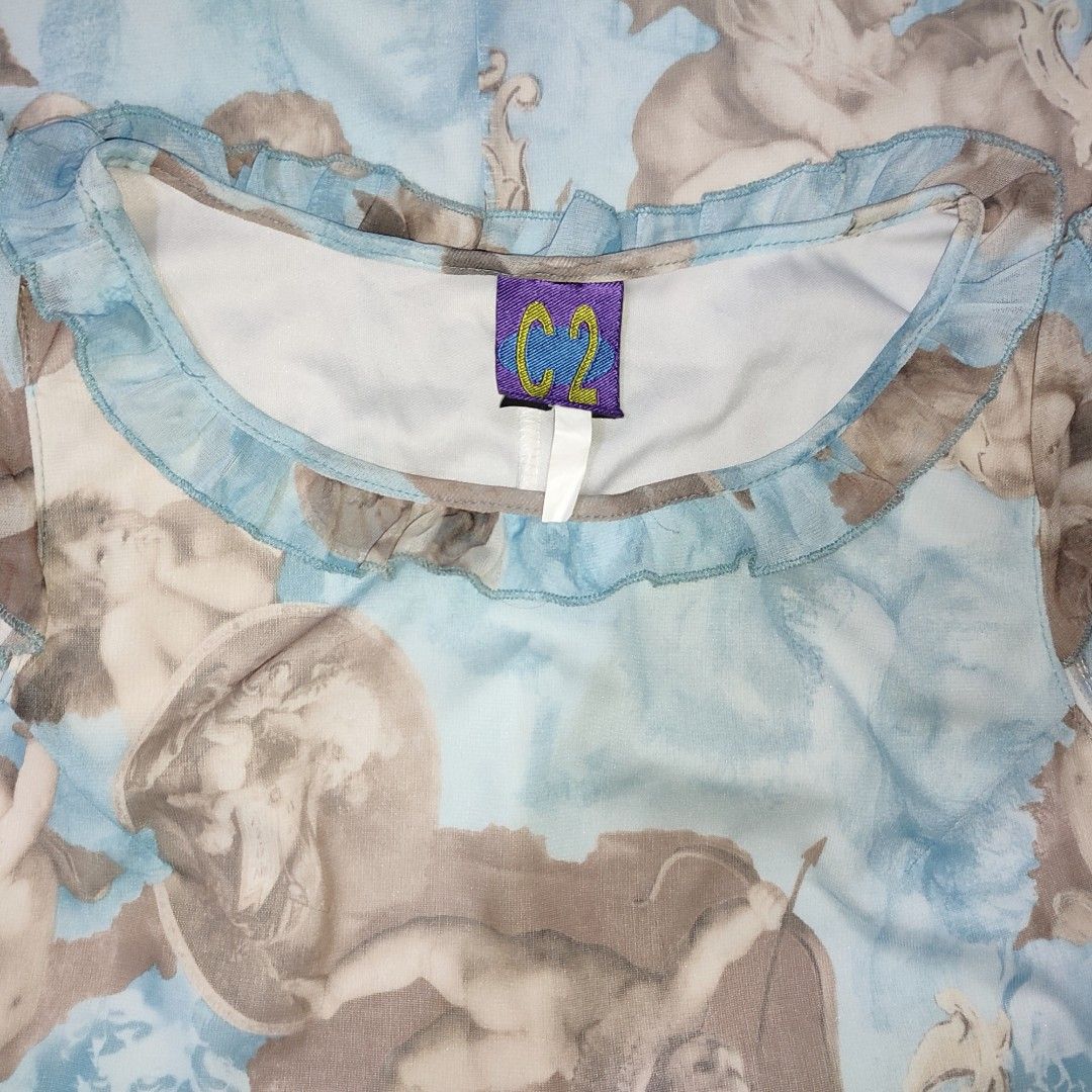 C2 Cherub Print Ruffle Neck Mini Dress (Category: Dresses) located in Caloocan City. Submitted by faesrie (Listing ID 1454171138, Image 2). Description: - Adorable blue dress with a unique cherub print. - Features charming ruffled neckline and sleeves. - Delicate sheer overlay fabric for added texture. - Flirty short length, ideal for making a statement. - Perfect for a standout, eye-catching look..