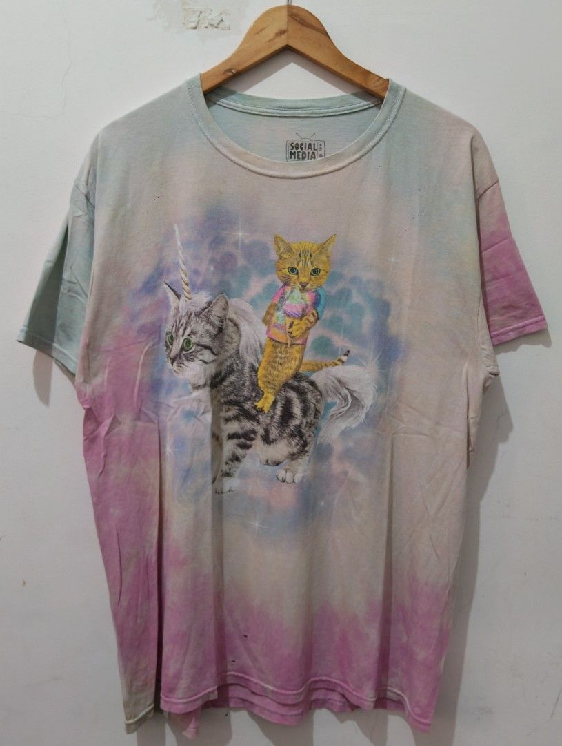 Cat Riding Unicorn Tie-Dye (Category: Tshirts & Polo Shirts ) located in Taguig. Submitted by wethrifting2021 (Listing ID 1454163882, Image 1). Description: Item: Unicorn Cat Tie dye 🔥 ‎Size: OPT Social Media (XL) ‎Width: 22 ‎Length: 28 ‎Condition: Good ‎Issue: Penhole, Hairline SWIPE MORE DETAILS. DM to purchase 📩.