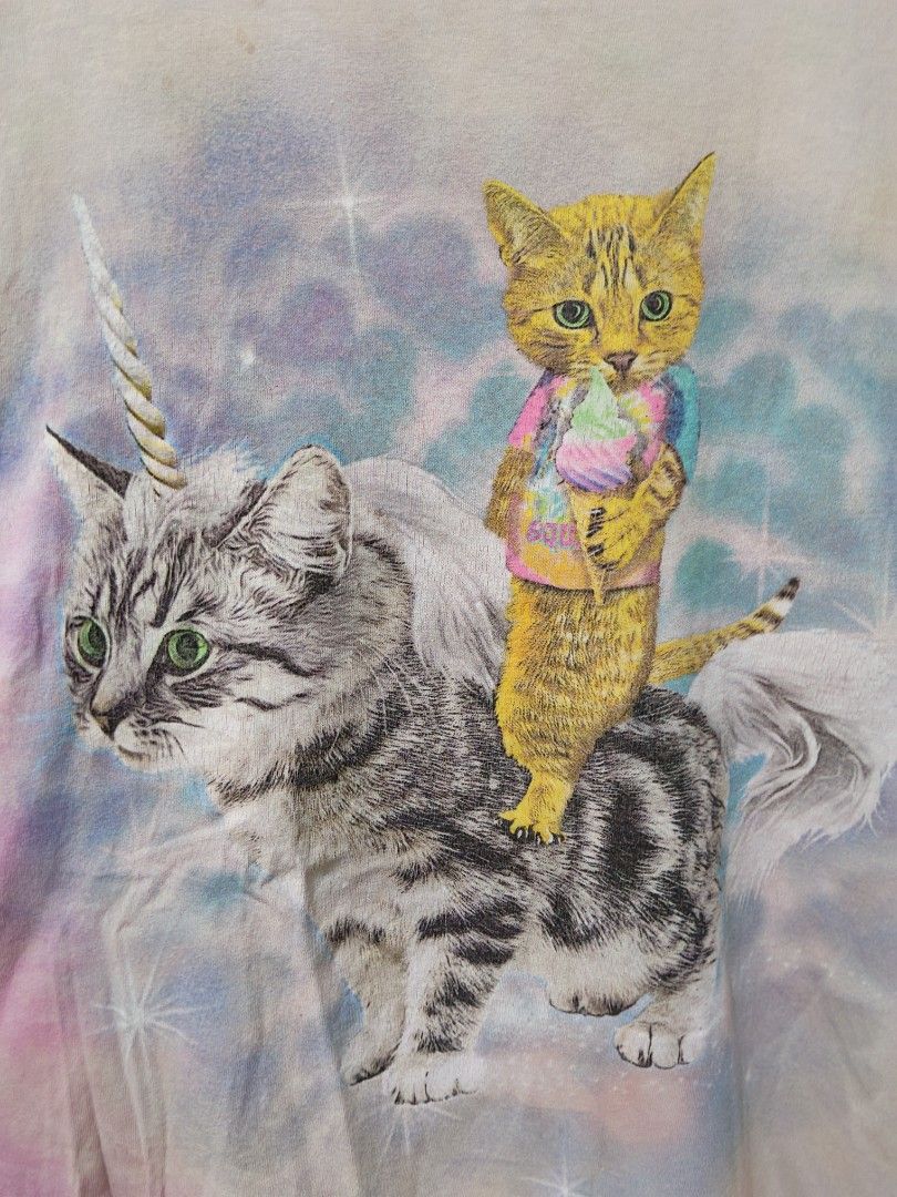 Cat Riding Unicorn Tie-Dye (Category: Tshirts & Polo Shirts ) located in Taguig. Submitted by wethrifting2021 (Listing ID 1454163882, Image 2). Description: Item: Unicorn Cat Tie dye 🔥 ‎Size: OPT Social Media (XL) ‎Width: 22 ‎Length: 28 ‎Condition: Good ‎Issue: Penhole, Hairline SWIPE MORE DETAILS. DM to purchase 📩.