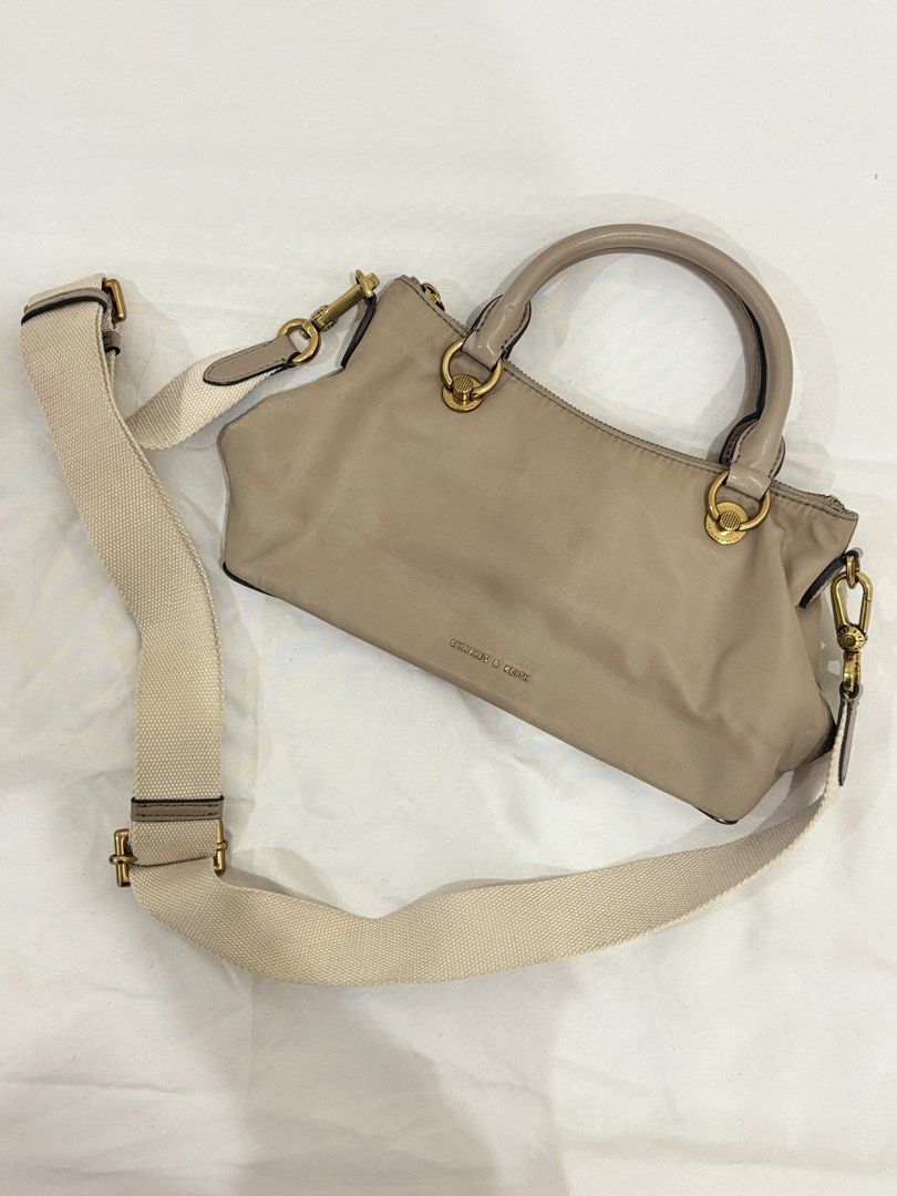 Charles & Keith Taupe Nylon Top Handle Bag with Strap (Category: Shoulder Bags) located in Marikina City. Submitted by beadc (Listing ID 1454160150, Image 1). Description: - Brand: Charles & Keith - Color: Taupe - Material: Nylon - Features: Top handles, detachable crossbody strap - Hardware: Gold details - Closure: Zip - Condition: Minor pink marks on the front (as pictured) - Ideal for: Everyday use.
