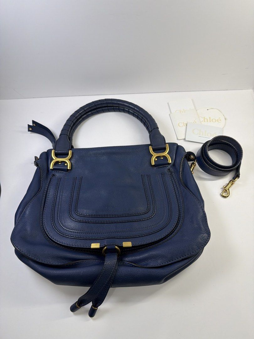 Authentic Chloe Marcie Medium Satchel Navy Blue Leather (Category: Luxury Bags & Wallets) located in Quezon City. Submitted by shoppingcartmnl (Listing ID 1454061495, Image 2). Description: - Authentic Chloe Marcie satchel - Deep navy blue pebbled leather - Gold hardware details - Top handle and detachable shoulder strap - Interior zip pocket and slip pocket - Dust bag and tags included - Great everyday bag.