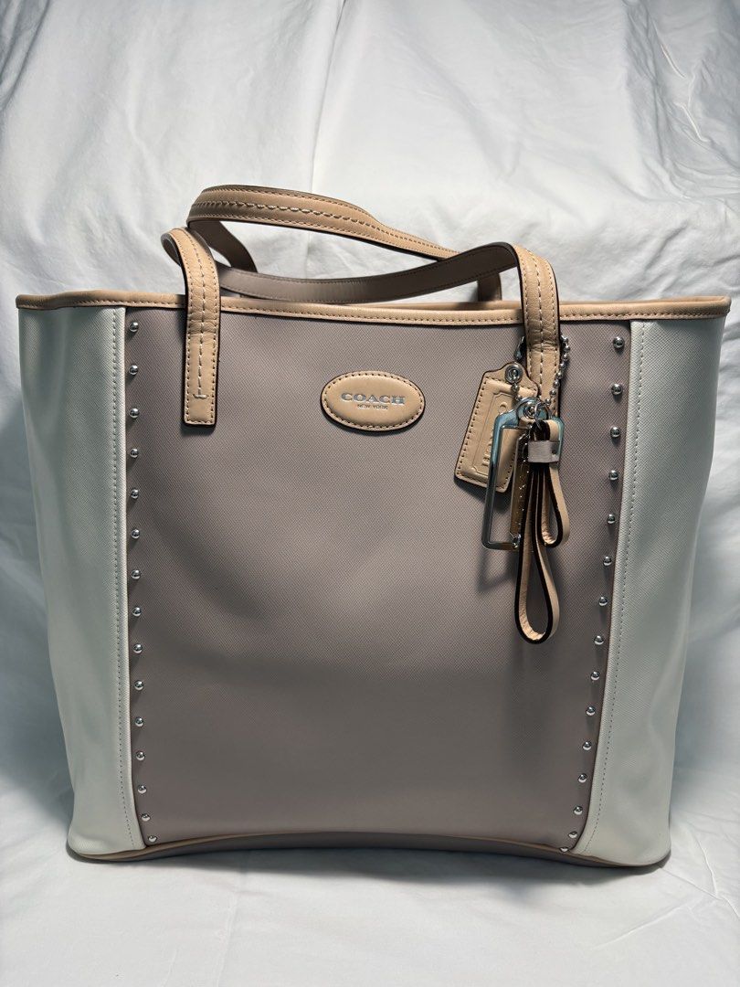 COACH TOTE BAG (Category: Luxury Bags & Wallets) located in Taguig. Submitted by vittelina (Listing ID 1454036612, Image 1). Description: -Color Block design Taupe center Cream side Panels and Beige trim -no discoloration on the body of the bag. Some scratches at the top and bottom sides of the bag. Still very nice and presentable looking, clean. A bit of stain mark at the interior. Can send pics upon request -Bought at Coach Outlet -100% Genuine