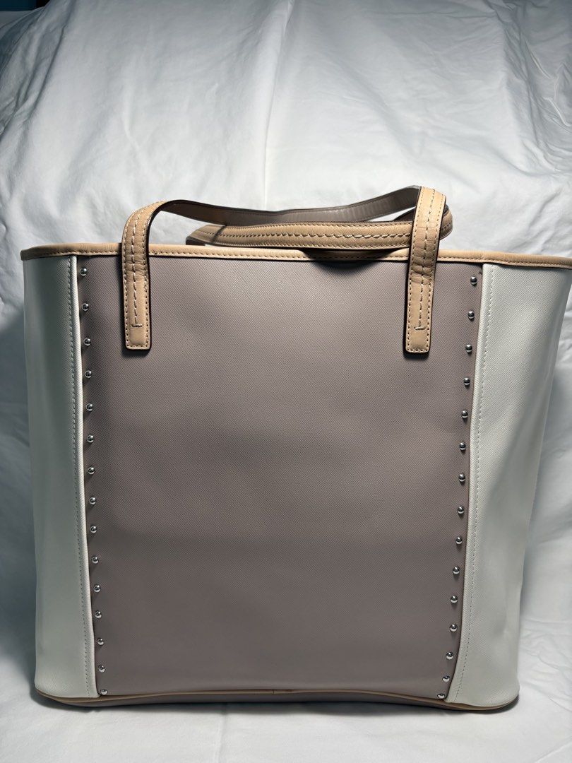 COACH TOTE BAG (Category: Luxury Bags & Wallets) located in Taguig. Submitted by vittelina (Listing ID 1454036612, Image 2). Description: -Color Block design Taupe center Cream side Panels and Beige trim -no discoloration on the body of the bag. Some scratches at the top and bottom sides of the bag. Still very nice and presentable looking, clean. A bit of stain mark at the interior. Can send pics upon request -Bought at Coach Outlet -100% Genuine