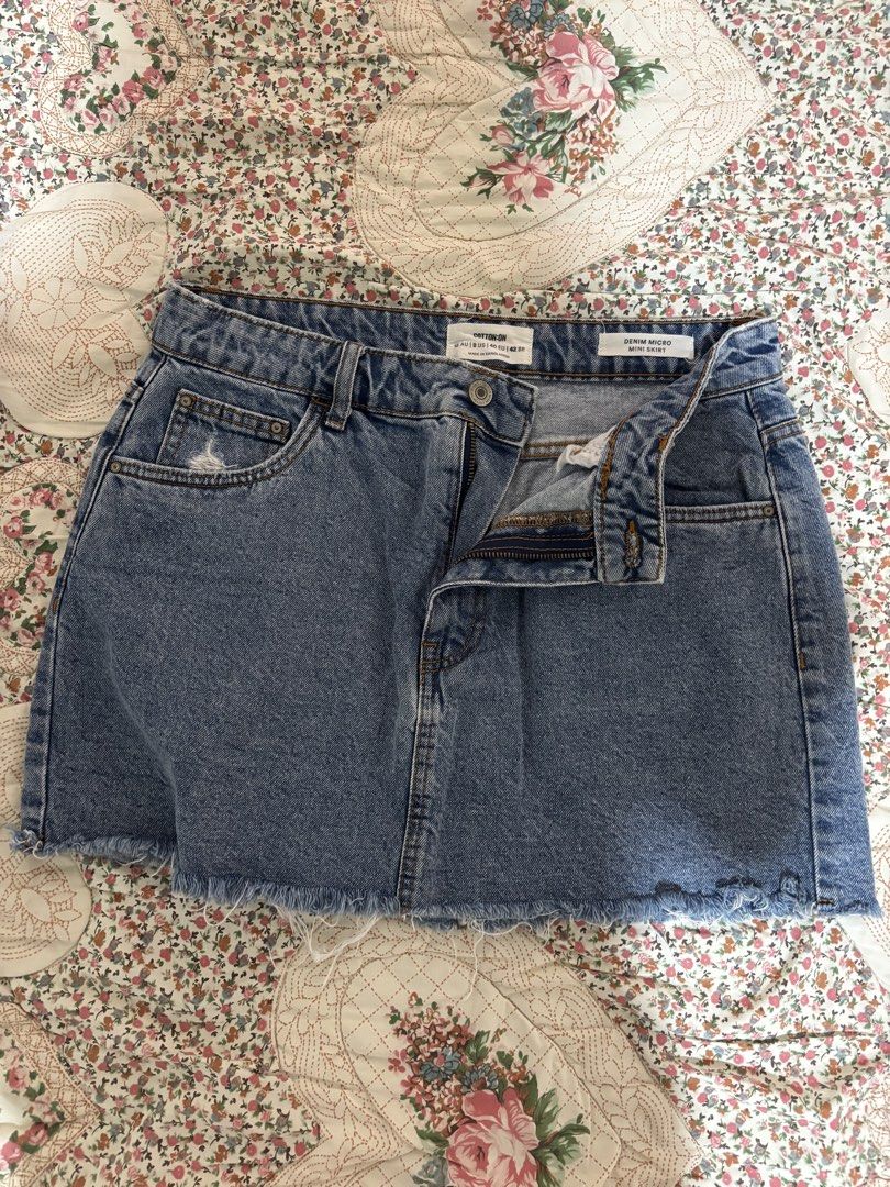 Cotton On Denim Mini Skirt (Category: Skirts) located in Taguig. Submitted by applefie (Listing ID 1454063158, Image 1). Description: - Blue denim mini skirt from Cotton On - Features a frayed hem detail - Ripped detail on the back pocket - Zipper and button closure at the front - Classic five-pocket styling - Ideal for casual wear Waist: 31 inch.