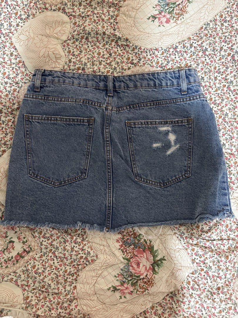Cotton On Denim Mini Skirt (Category: Skirts) located in Taguig. Submitted by applefie (Listing ID 1454063158, Image 2). Description: - Blue denim mini skirt from Cotton On - Features a frayed hem detail - Ripped detail on the back pocket - Zipper and button closure at the front - Classic five-pocket styling - Ideal for casual wear Waist: 31 inch.