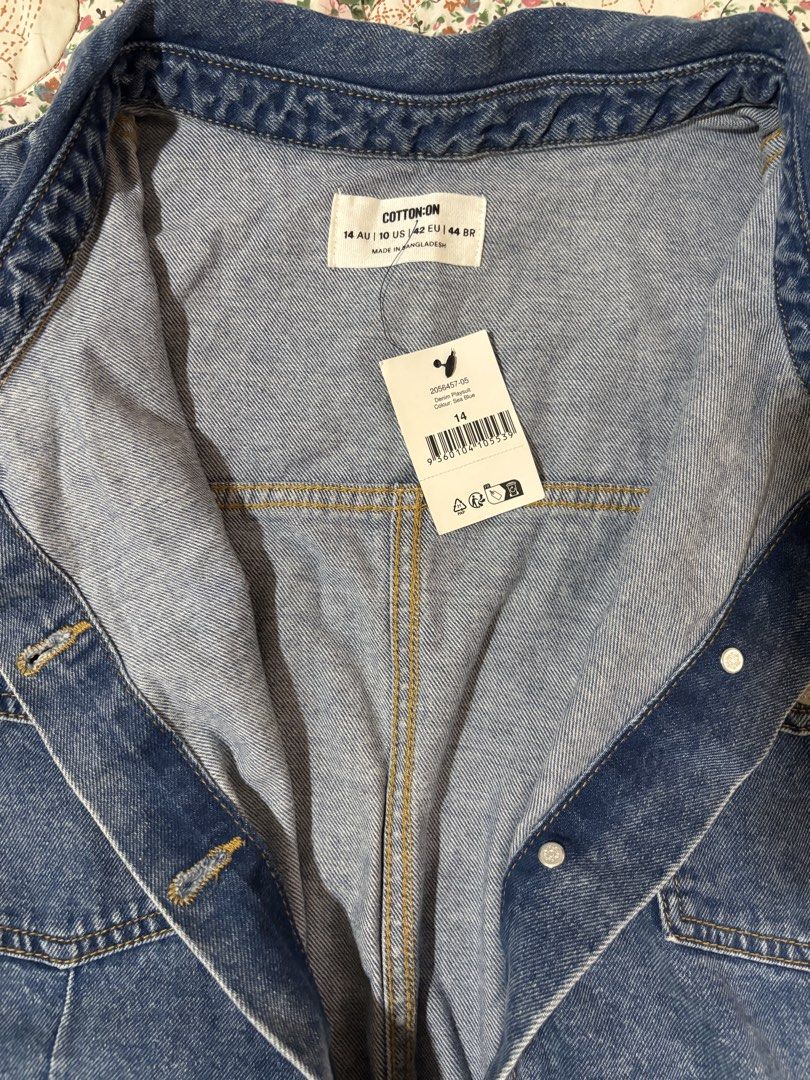 XL Cotton On Denim Playsuits (Category: Rompers) located in Taguig. Submitted by applefie (Listing ID 1454061107, Image 3). Description: - Brand: Cotton On - Style: Denim Playsuit - Color: Blue Denim - Features: Button-down front, two chest pockets, elasticated waistband, rolled sleeve cuffs, rolled hem shorts. - Material: Denim - Condition: New with tags (as shown in images) - Perfect for casual outings and everyday wear..
