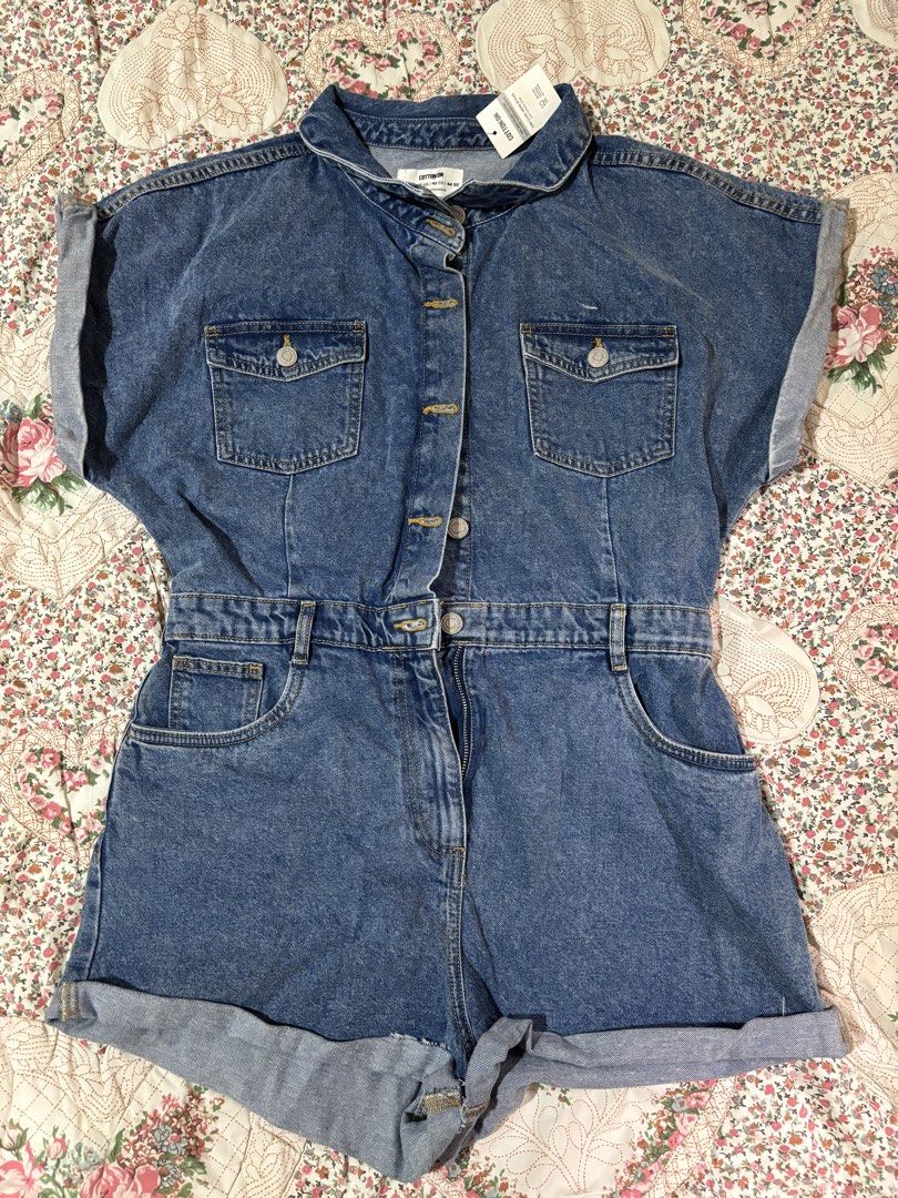 XL Cotton On Denim Playsuits (Category: Rompers) located in Taguig. Submitted by applefie (Listing ID 1454061107, Image 2). Description: - Brand: Cotton On - Style: Denim Playsuit - Color: Blue Denim - Features: Button-down front, two chest pockets, elasticated waistband, rolled sleeve cuffs, rolled hem shorts. - Material: Denim - Condition: New with tags (as shown in images) - Perfect for casual outings and everyday wear..